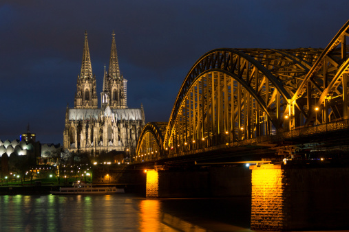people enjoy to walk along the promenade at the Hohenzollern bridge in Cologne, Germany. It is the most heavily used railway bridge in Germany.