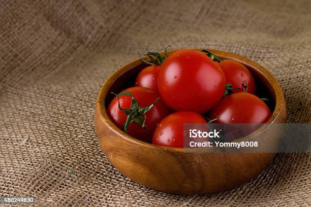 Bowl From Exotic Wood Full Of Tomatoes Stock Photo - Download Image Now - 2015, Agriculture, Biology