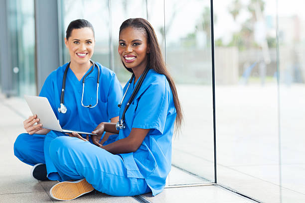 istock female doctors sitting on the floor 480252561