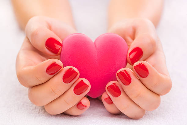 Closeup red manicure on the white towel