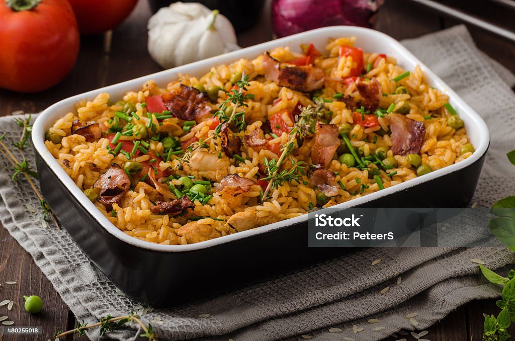 Cajun chicken with rice Cajun chicken with rice,  full of flavor and hot spices with fresh vegetable bio peas 2015 Stock Photo