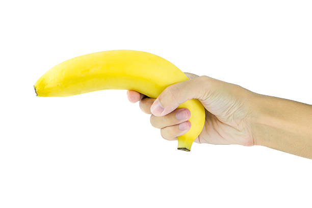 istock Banana in hand like a gun on white background 480255626