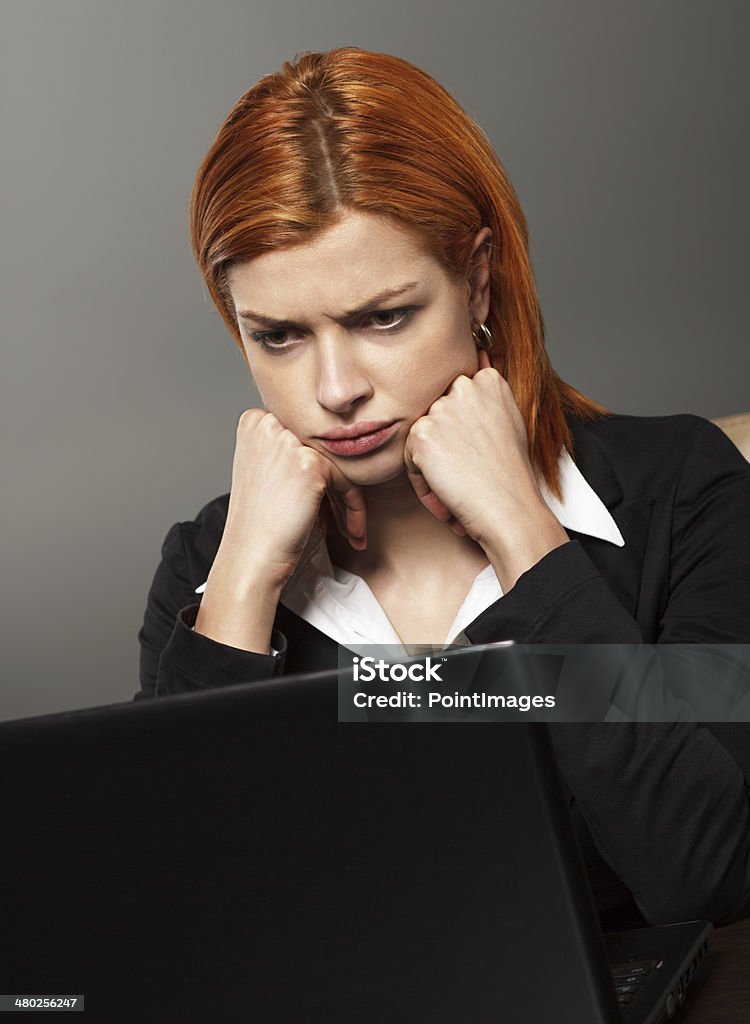 Worried Businesswoman Worried Businesswoman looking at laptop, front view. 20-24 Years Stock Photo