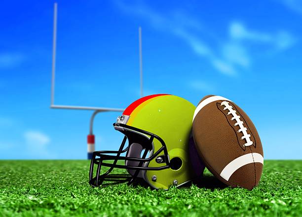 istock Football Ball and Helmet On Grass 480256821