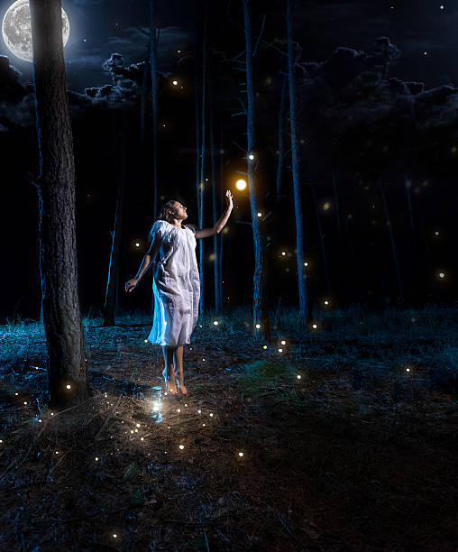 istock young woman at night forest with full moon jumping high 480258784