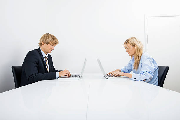 istock Businesspeople working on laptops in office 480259869
