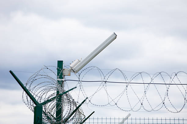 istock Wired fence with rolled barbed wires on white background 480260084