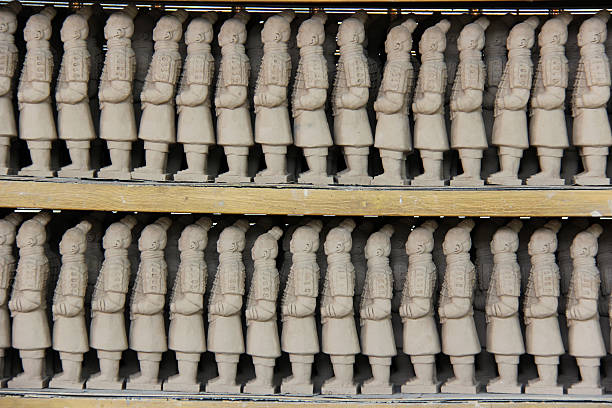 istock Minature Terra Cotta Warrior Souvenirs Lined Up On Shelf 480262567