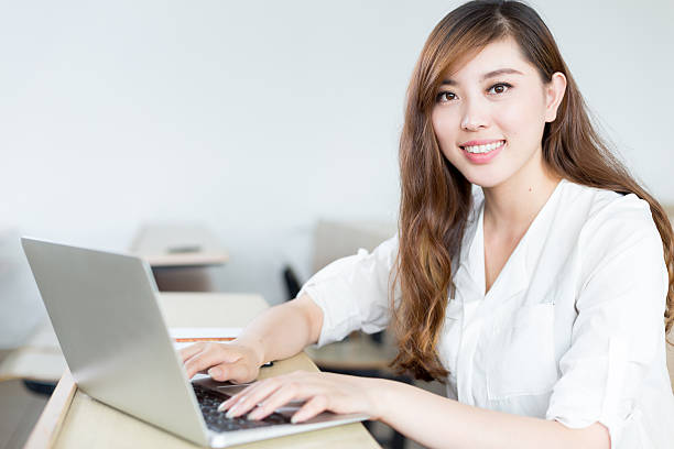 istock Asian  beautiful female student study with laptop in classroom 480266628