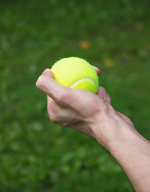 istock tennis ball in man hand close up 480267464