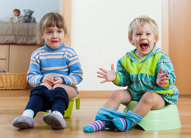 istock Two emotional siblings  on chamber pots 480268755