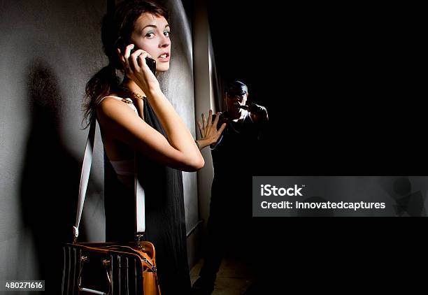 Woman Calling 911 For Help In An Alley Stock Photo - Download Image Now - Using Phone, Emergency Services Occupation, Fear
