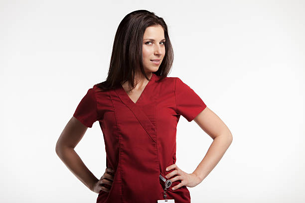 Nurse in red scrubs portrait. Studio shot on white background.