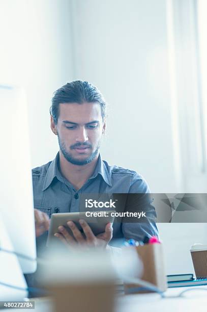 Modern Businessman Using Digital Tablet Stock Photo - Download Image Now - 20-29 Years, 2015, Adult