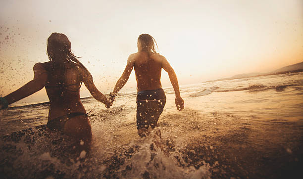 istock Couple running in the water 480272826