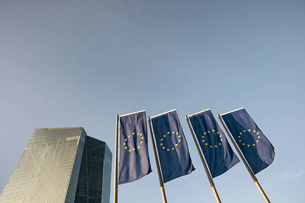 Frankfurt, Germany - Pedestrians passing the Euro Symbol, a sculpture by Ottmar Hörl, in Frankfurt's central business district.