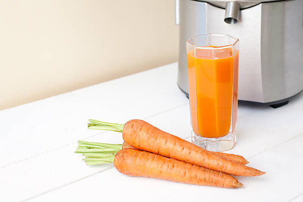 istock fresh carrot juice with juicer 480277182