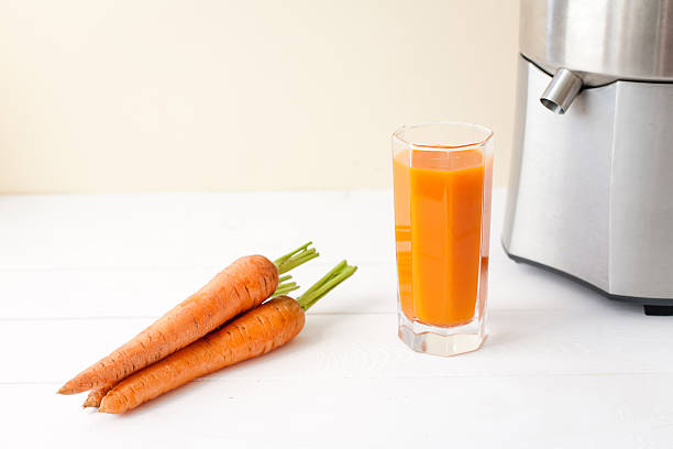 istock fresh carrot juice with juicer 480277348