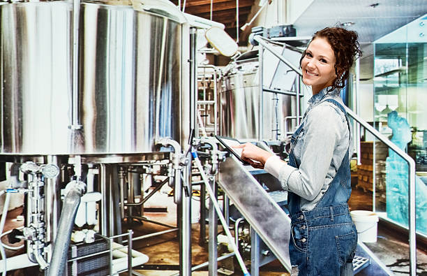 istock Smiling female brewmaster working in industry 480277368