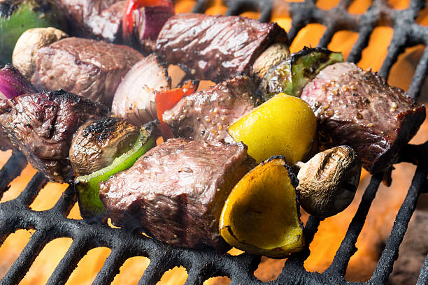 istock Delicious Beef Shish Kebab on a Grill with Flames` 480277414