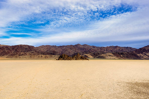 istock Dry lake bed with cracked mud surrounded with rocks 480277870