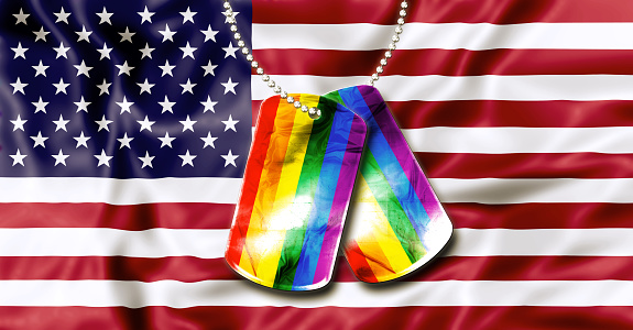 American flag background and army dogtags with rainbow flag of pride. Concept of  opening to the free expression of any sexual orientation.