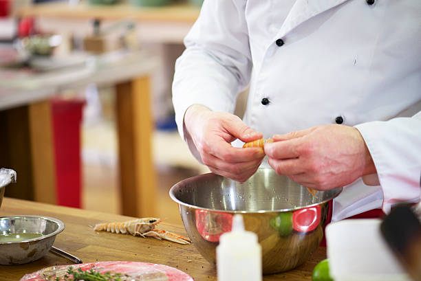 istock chef expert hands clean Scampi prawns in the kitchen 480280684