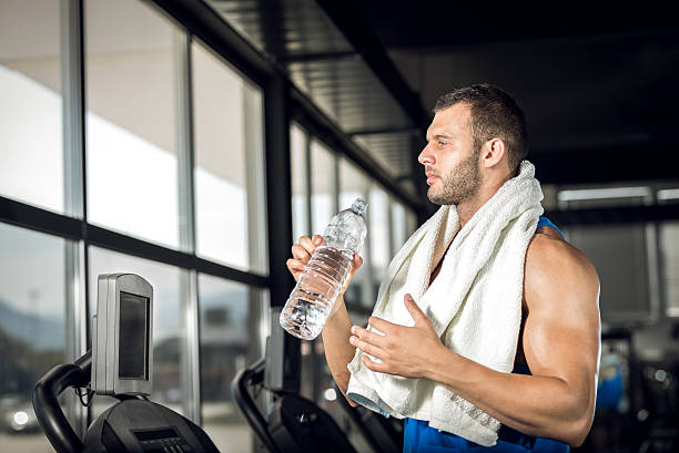istock Young man drinking water in gym 480281098