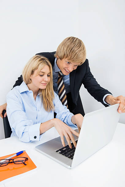 istock Businesspeople using laptop at desk in office 480285097