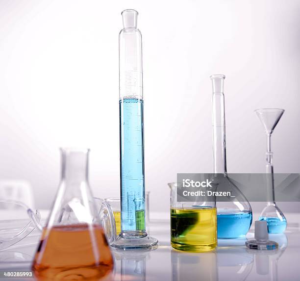Laboratory Equipment Filled With Colorful Solutions With Tubing And Beaker Stock Photo - Download Image Now