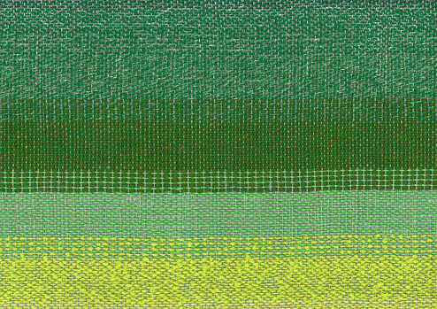 Handwoven geometric pattern in green and yellow.
