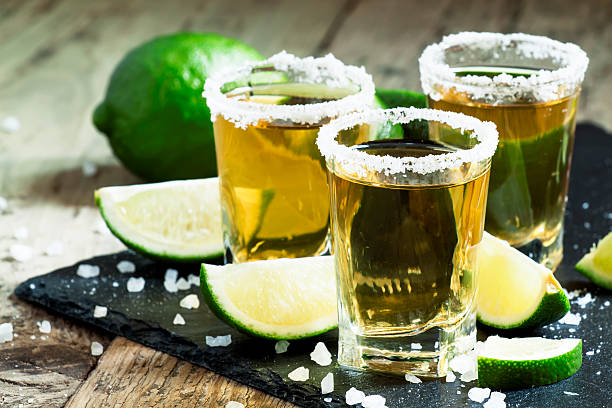 Gold Mexican tequila with lime and salt Gold Mexican tequila with lime and salt, selective focus tequila drink photos stock pictures, royalty-free photos & images