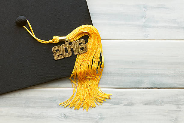 istock Black and Gold 2016 Graduation White Wood Background 480288472