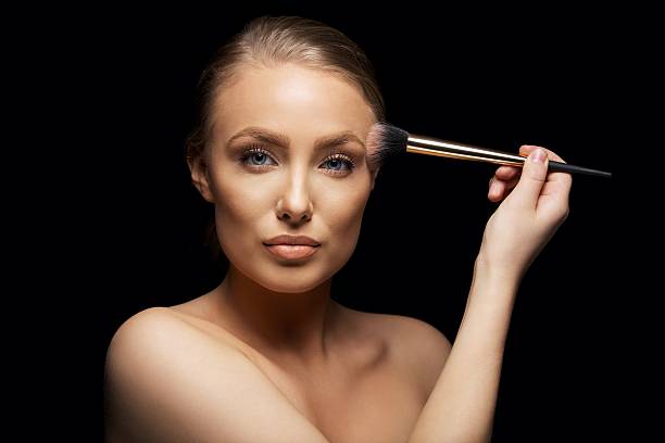 istock Pretty young female fashion model putting on make up 480288909