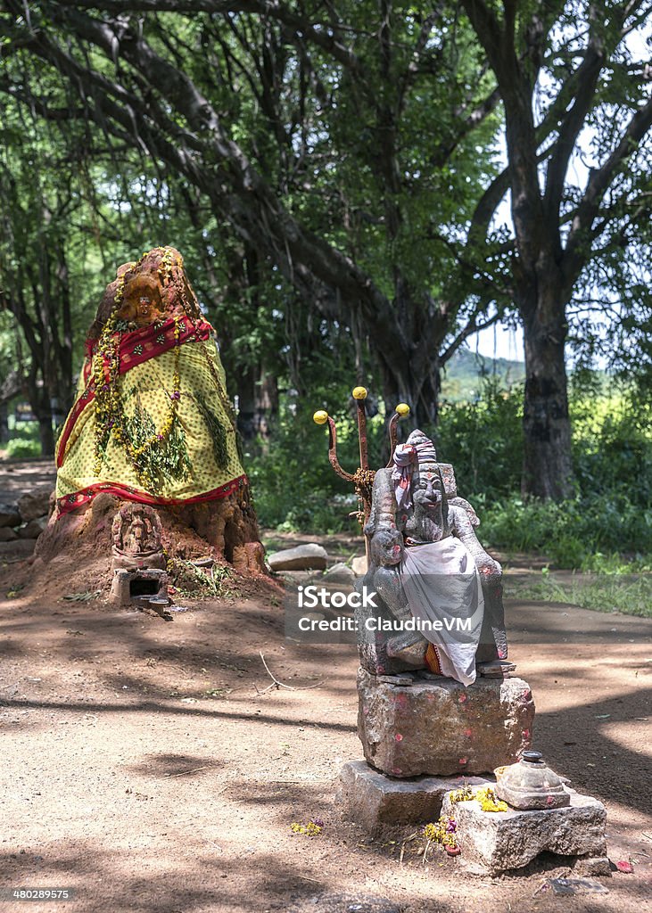 Old ant-hill converted into shrine for Manasa, the snake-goddess. Old ant-hill converted into shrine for Manasa, the snake-goddess. The man with the trident is known as “Karuppannaswamy.” He is a demi-god servant of Manasa and the protector of the shrine. Ant Stock Photo
