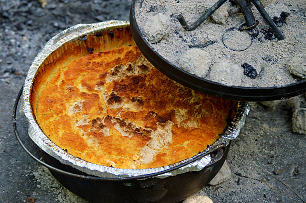 Dutch Oven Peach Cobbler Cooking with charcoals Dutch oven peach cobbler cobbler dessert stock pictures, royalty-free photos & images