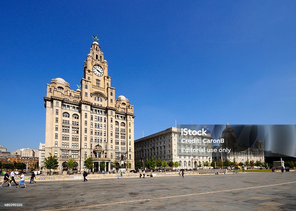The Three Graces, Liverpool. Liverpool, United Kingdom - June 11, 2015: The Three Graces consisting of the Liver Building, Port of Liverpool Building and the Cunard Building with tourists enjoying the sights, Liverpool, Merseyside, England, UK, Western Europe. City Stock Photo