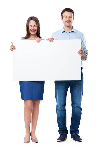 istock Woman and man holding a placard 480290837