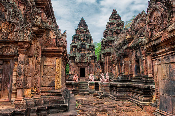 Forgotten temple Banteay Srei - a 10th century Hindu temple dedicated to Shiva. The temple built in red sandstone was forgotten for centuries and rediscovered 1814 in the jungle of the Angkor area of Cambodia. cambodia stock pictures, royalty-free photos & images