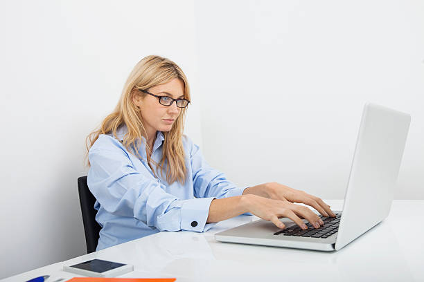 istock Young businesswoman using laptop at desk in office 480294653