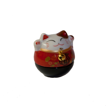 Maneki Neko - Lucky Cat in White Background. The maneki-neko is a common Japanese figurine (lucky charm, talisman)