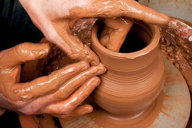 istock hands of a potter, creating an earthen jar 480296333