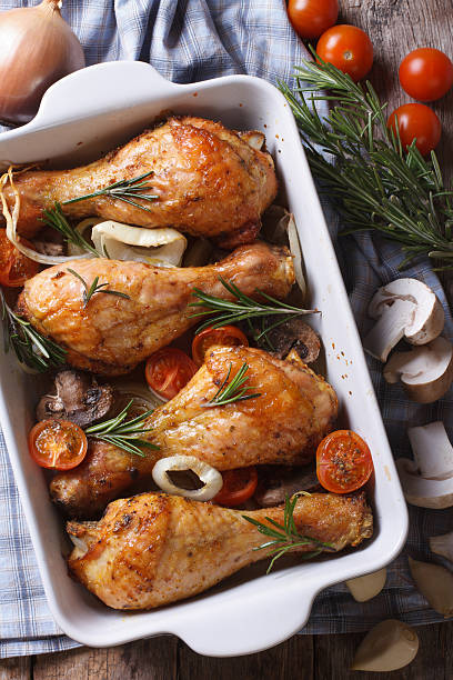 istock Baked chicken legs and ingredients. vertical top view close-up 480297650
