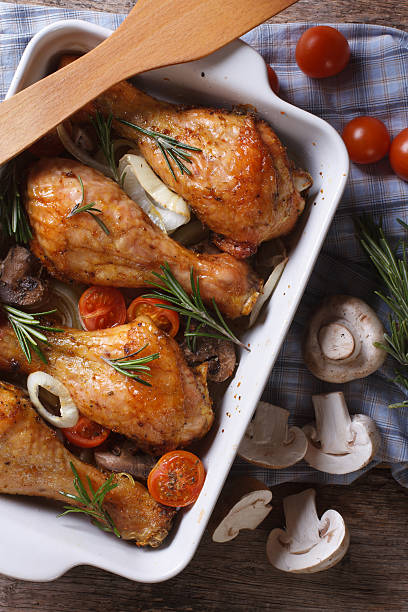 istock Baked Chicken drumsticks with vegetables closeup. vertical top v 480297904