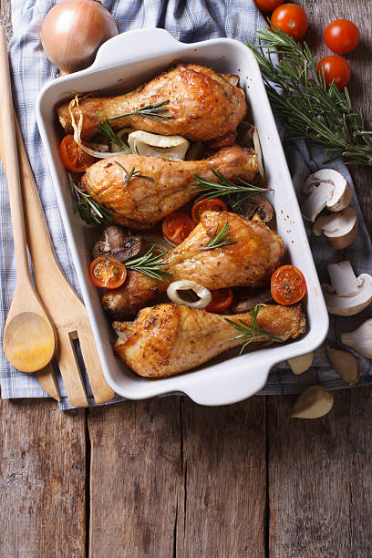 istock Baked chicken legs and ingredients. vertical top view 480297906