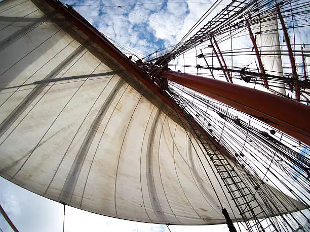 looking up at sails on old sailboat or tallship