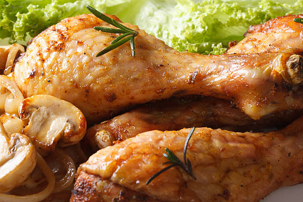 istock Fried chicken legs with mushrooms and lettuce macro. horizontal 480298560