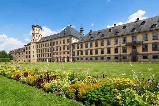 Fulda, Germany - June 29, 2015: The baroque Fuldaer Stadtschloss with formal garden and flower beds in June.