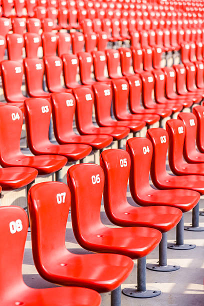 istock Red chairs bleachers in large stadium 480298771