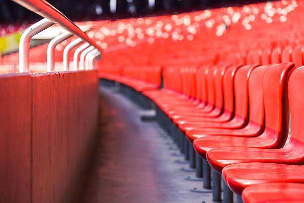 istock Red chairs bleachers in large stadium 480298781